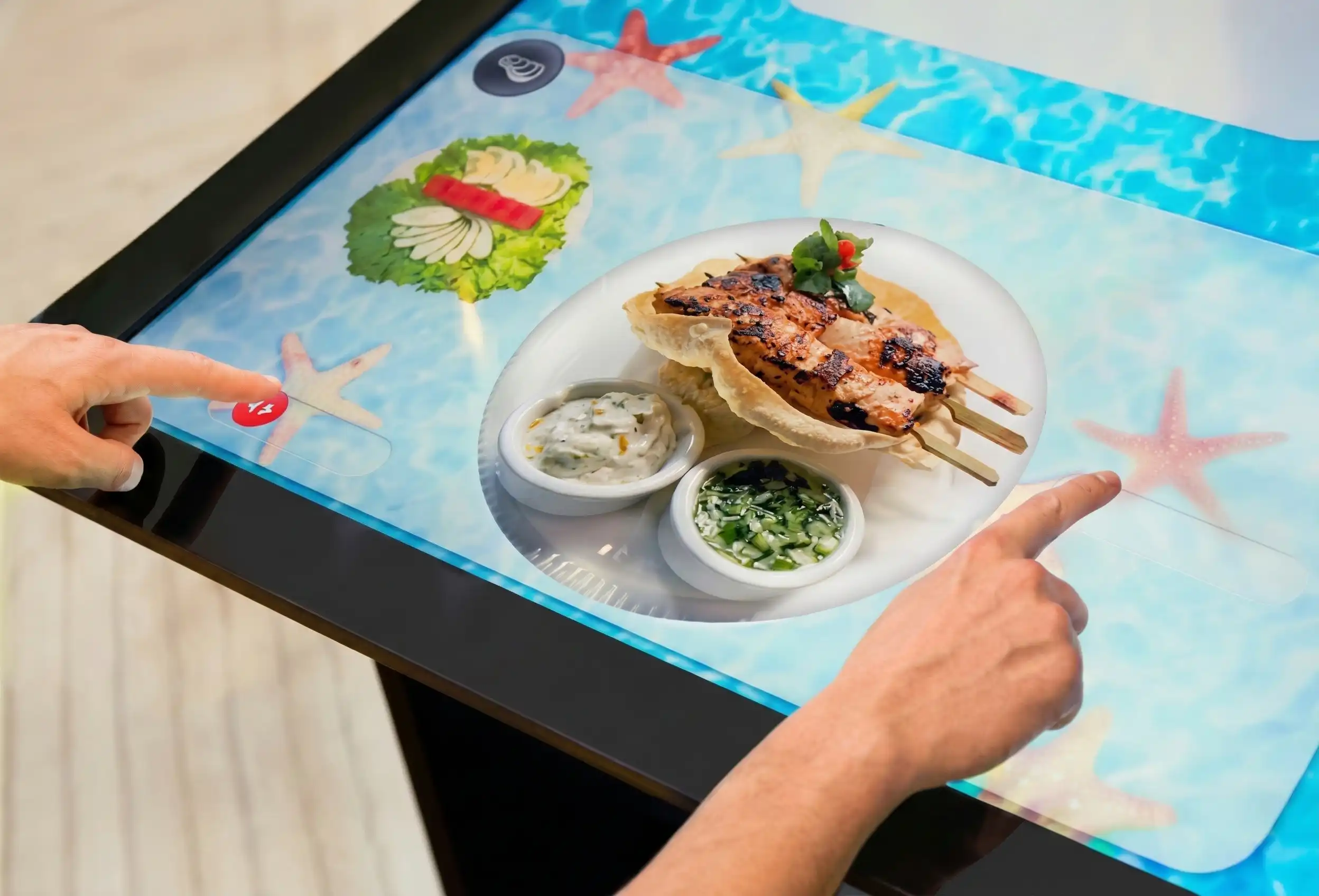Patrons using a multi-touch interactive dining table to order Pan-Asian food at Inamo restaurant in London.