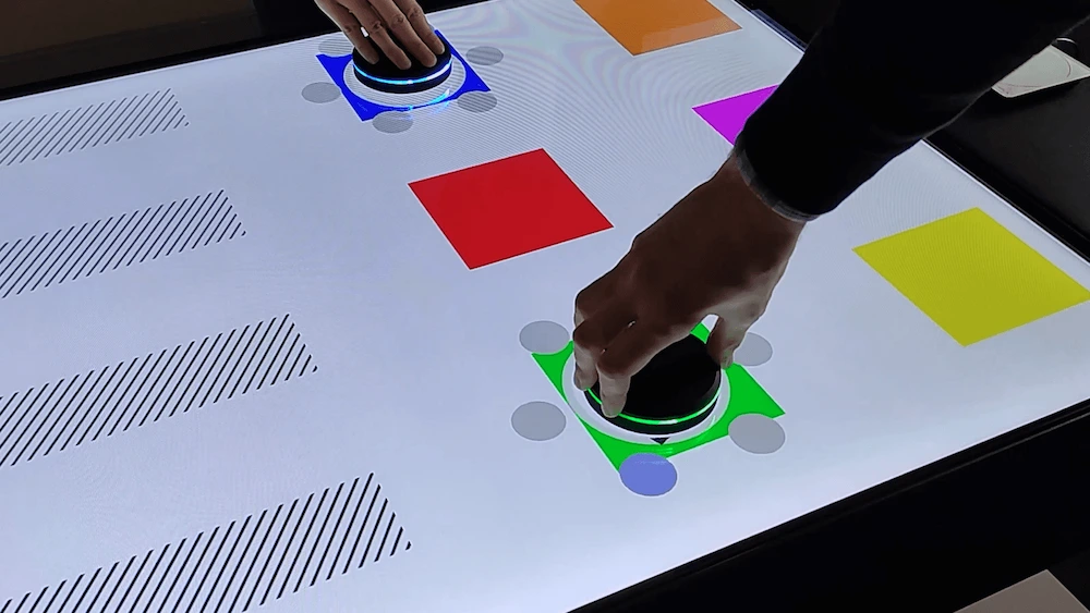 Users interacting with the Object Recognition Interactive Table in a commercial exhibition scenario