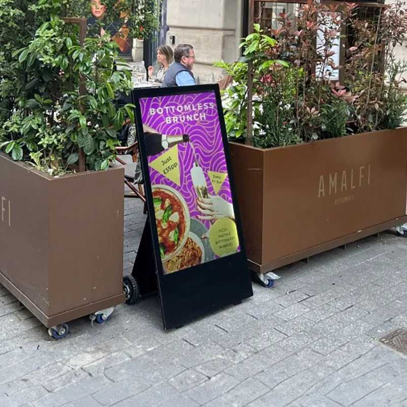 pavement advertising board on a pedestrian street outside a restaurant